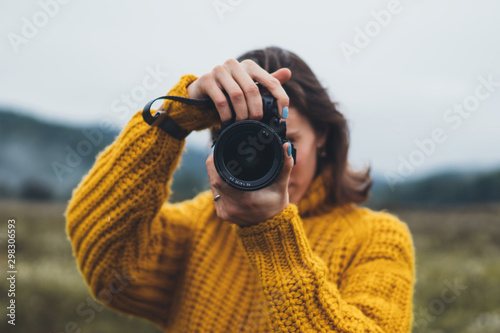 photographer girl take photo on camera closeup on background autumn foggy mountain, tourist shooting nature mist landscape, hobby concept, copy space photo