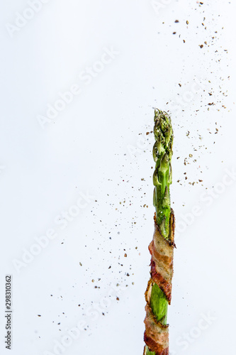 Asparagus stalk wrapped with bacon and spices