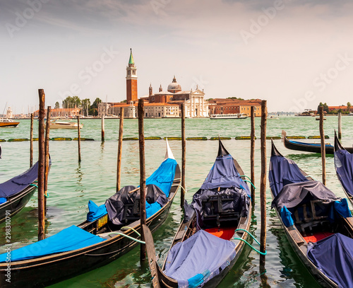 picturesque view at a berth in a Venice chanel vith gondolas and nice old builginds on the other side at San Giorgio Maggiore and Giudecca © Yaroslav