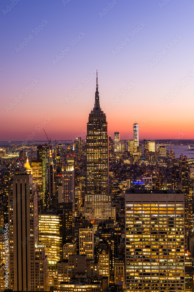 Naklejka premium New York City skyline with cityscape and skyscraper in Manhattan at sunset.