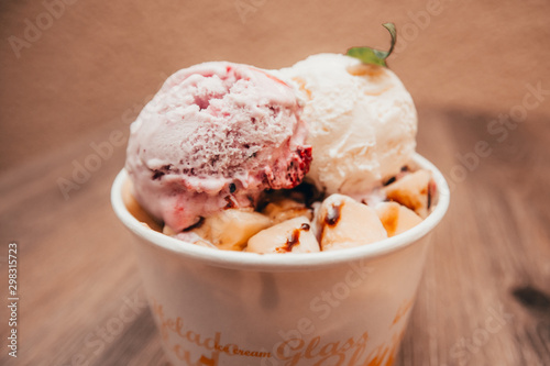 ice cream with sprig of mint in paper cup