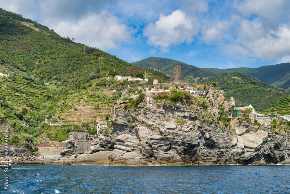 Ligurian Sea coast, view of coastal cliffs, beach, old lookout tower, Italy