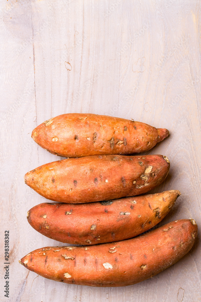 sweet potatoes on wooden background, copy space sweet potatoes on wooden background, copy space