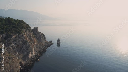 Aerial view rocky cliff shore in Crimea during golden dawn photo