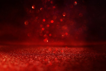background of abstract red, gold and black glitter lights. defocused