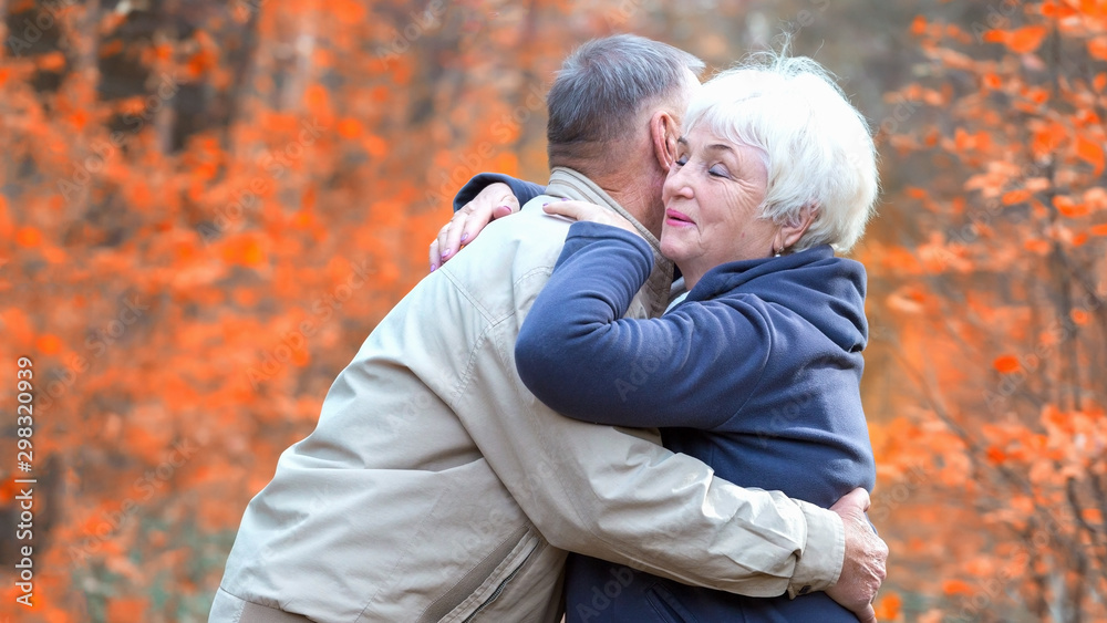 Fototapeta premium Senior woman hugs man and smiling