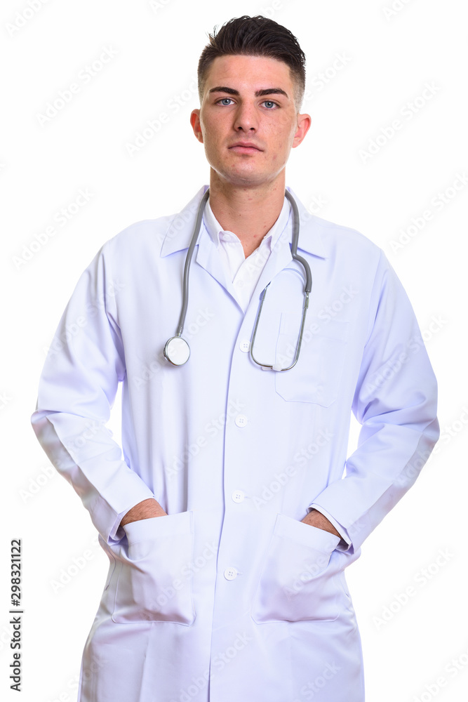 Studio shot of young handsome man doctor standing Studio shot of young handsome man doctor standing