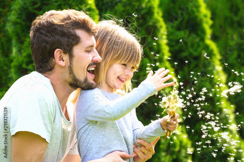 Daughter and her father have fun in summer garden