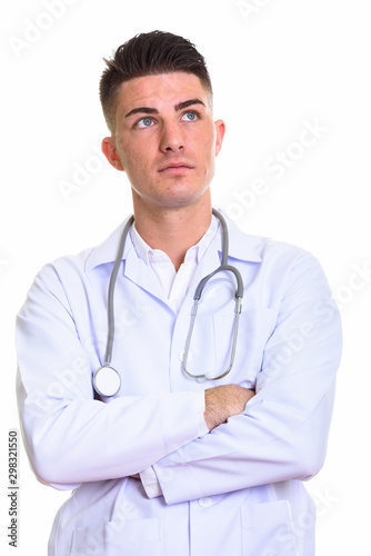 Studio shot of young handsome man doctor thinking with arms cros © Ranta Images