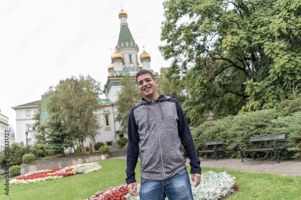 Obraz premium Young man smiling in the streets of Sofia .