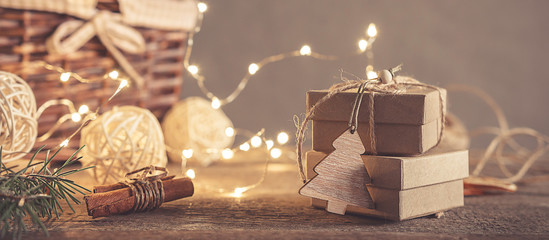 Christmas and zero waste, eco friendly packaging gifts in kraft paper on a wooden table, eco christmas holiday concept, eco decor banner