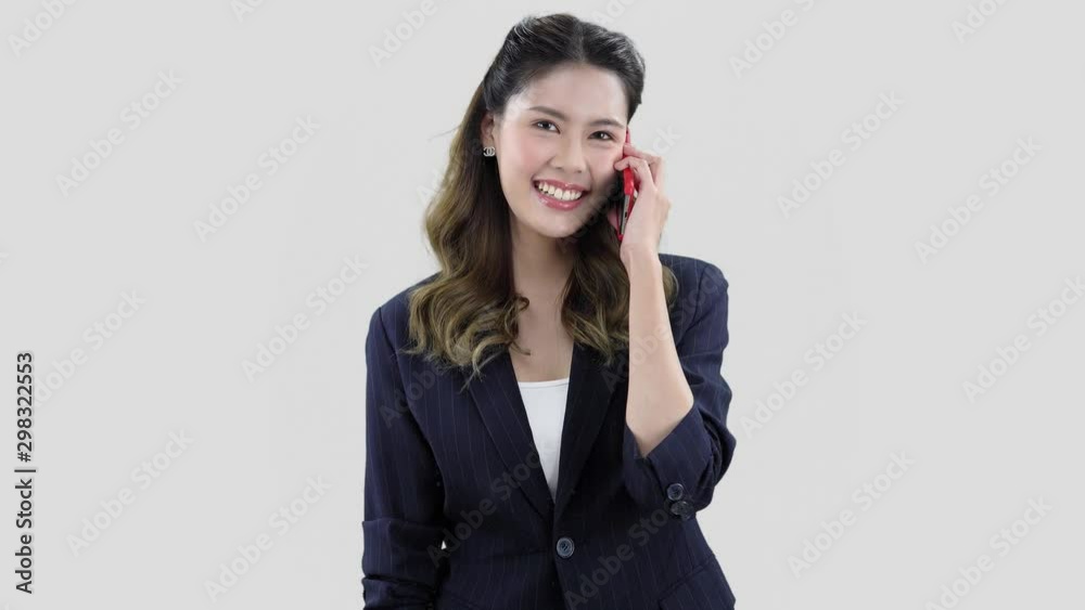 happy asian model dressed in dark blue jacket, smiling girl talks on her phone happy asian model dressed in dark blue jacket, smiling girl talks on her phone