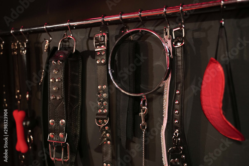Whips for BDSM on a dark background. Accessory for sexual games. photo