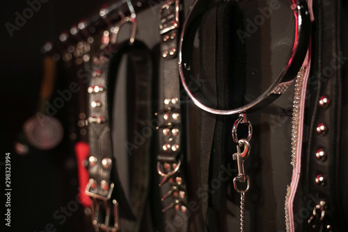 Whips for BDSM on a dark background. Accessory for sexual games. photo