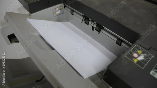 Office printer at work. Sheets of paper in a copier.