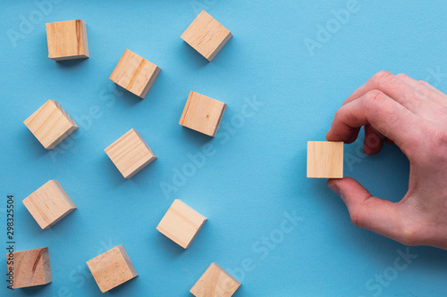 Hand choosing a wooden block from a set. Business choice concept photo