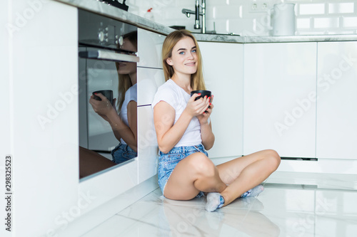 Woman smelling coffee. Young woman smelling coffee while having breakfast