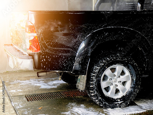 Car wash foam. Car wash shampoo that is injected into clean the dirt from the white car. In the car wash business