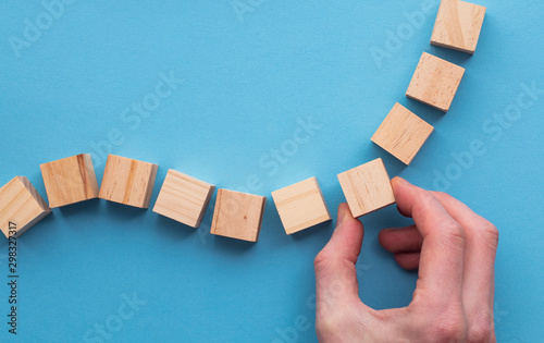 Hand choosing a wooden block from a set. Business choice concept photo