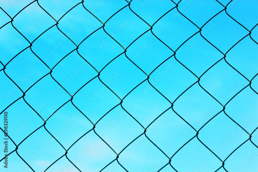 Black metal mesh on the background and blue sky