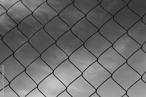 Black metal mesh on the background and blue sky