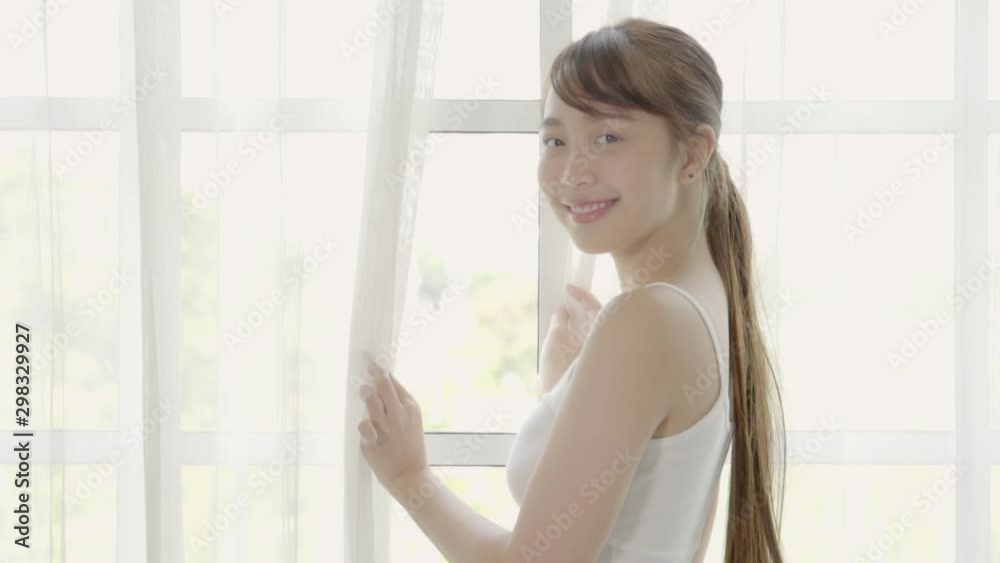 Beautiful closeup portrait young asian woman with smiling and laughing in bedroom, asia girl happy looking at camera with happy and funny, slow motion, health care and wellness concept.