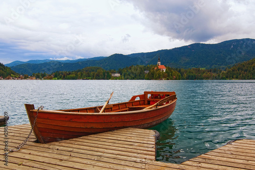 Picturesque nature landscape with one wooden boat moored on Bled Lake  Blejsko jezero . Famous touristic place and travel destination in Europe. Bled  Slovenia