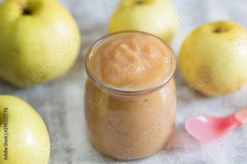 Apple sauce in glass jar on the white background