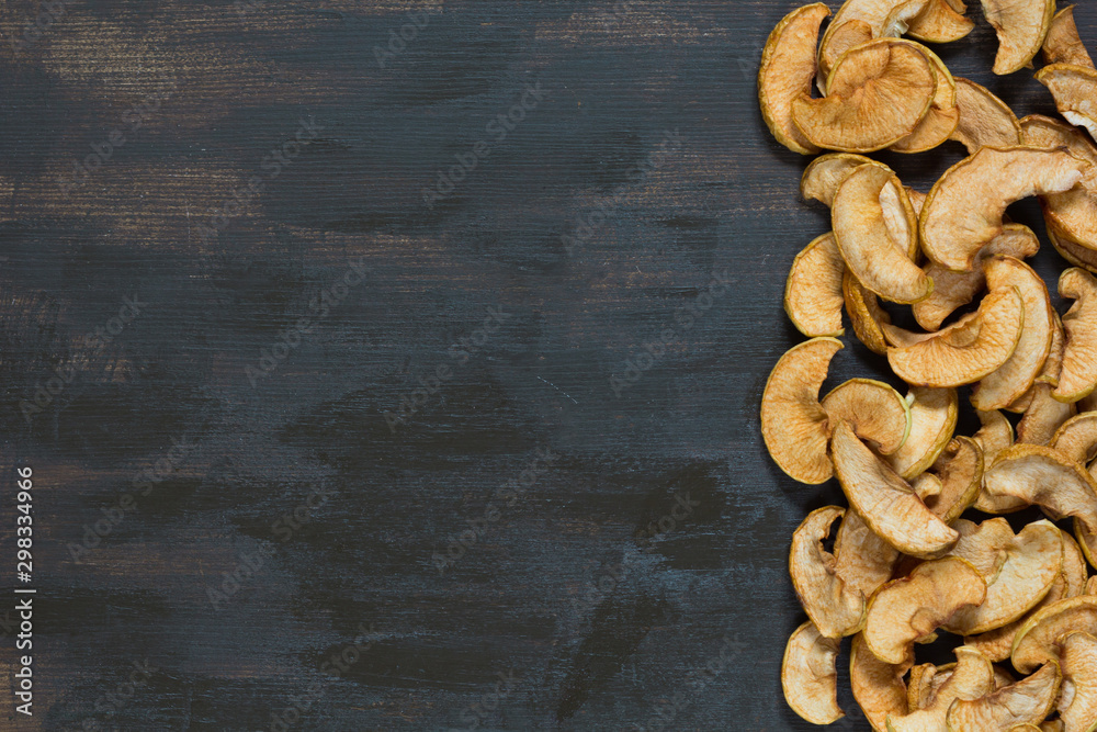 Fototapeta premium Flat lay with dried apple on the brown background