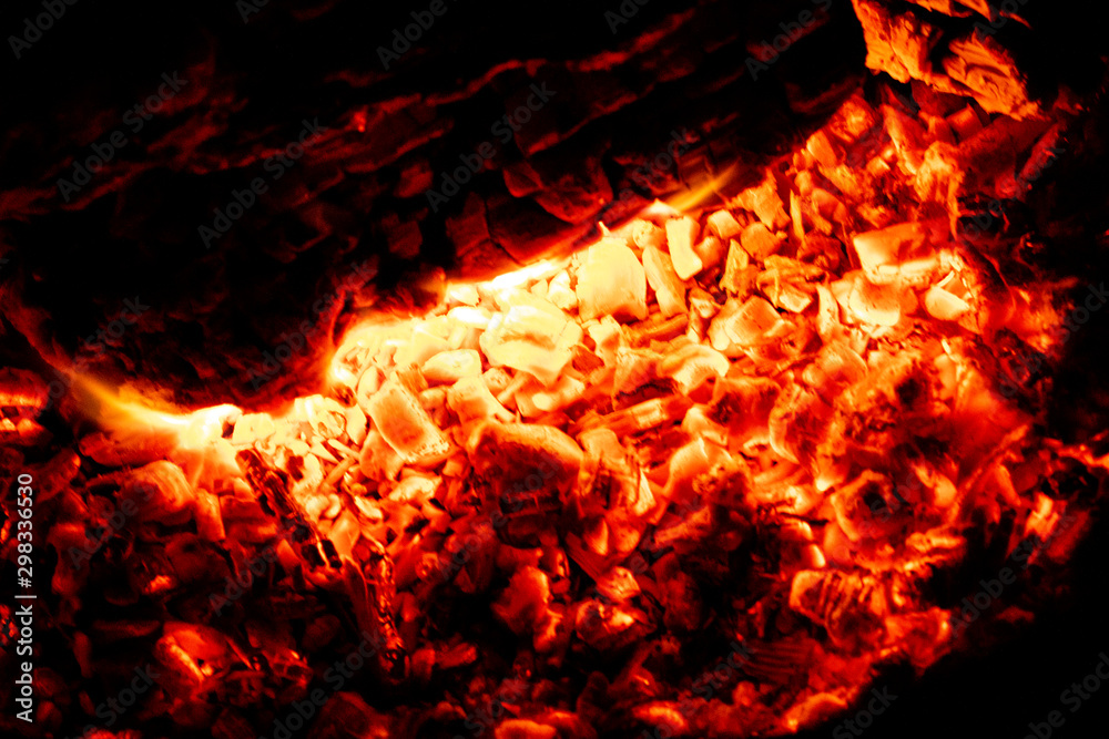 Incandescent details of orange and red charcoal embers for barbecue at the picnic. Texture