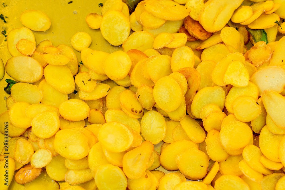 Fresh deep fried yellow potato chips displayed for sale at a street food market Fresh deep fried yellow potato chips displayed for sale at a street food market