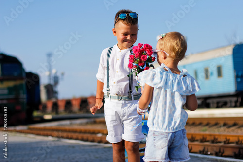 brother gives flowers to his sister