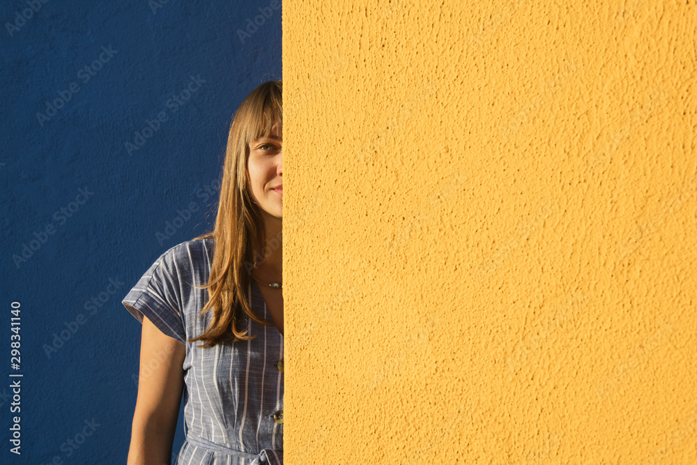 Portrait of a woman between yellow and blue walls