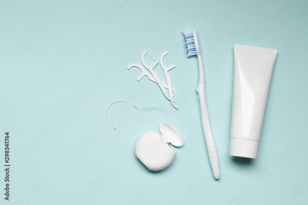 toothbrushes, toothpaste, dental floss on blue background. Dental care toothbrushes, toothpaste, dental floss on blue background. Dental care