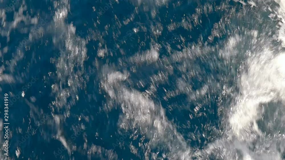 The movement and drilling of water from the work of the propeller on a boat in the sea, close-up The movement and drilling of water from the work of the propeller on a boat in the sea, close-up