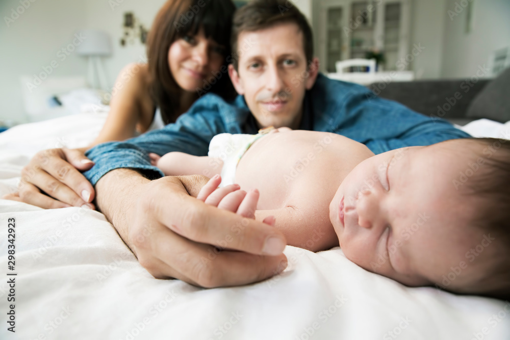Young parents with her newborn son at home