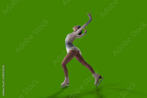 Photography Figure skating girl isolated on green background.