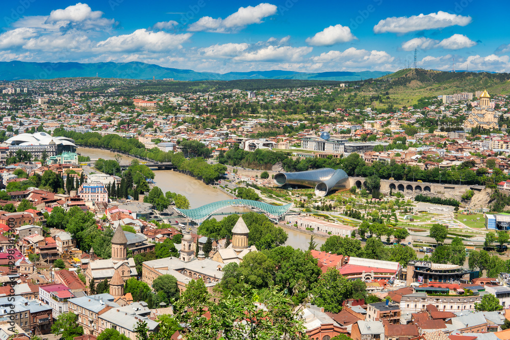 Tbilisi, Georgia - May 9, 2017. Panorama of the central part of the ancient city and the main attractions of the capital of Georgia. Sunny day, blue sky with clouds.