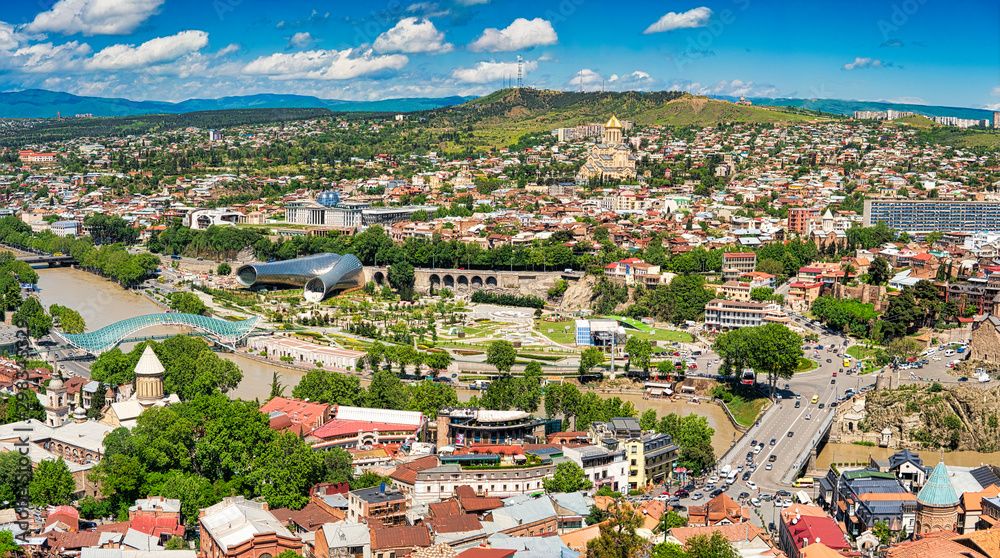 Tbilisi, Georgia - May 9, 2017. Panorama of the central part of the ancient city and the main attractions of the capital of Georgia. Sunny day, blue sky with clouds.