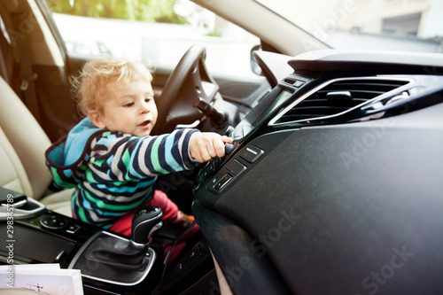 Germany, Bonn, Baby boy turning knob in car