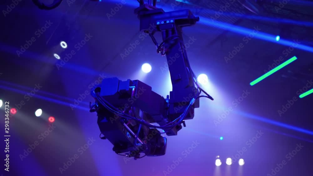 Video camera on the tap when shooting a television show. Live concert. The movement of the camera over the audience under the ceiling. Shooting from a height. Video camera on the tap when shooting a television show. Live concert. The movement of the camera over the audience under the ceiling. Shooting from a height.