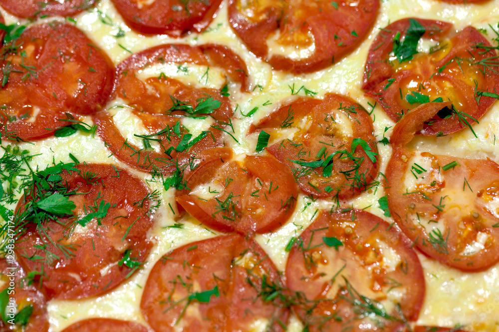 Pizza with cheese and tomatoes closeup
