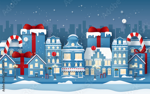 Origami Paper art of background of town with Christmas gift in winter season, Merry Christmas and Happy New Year