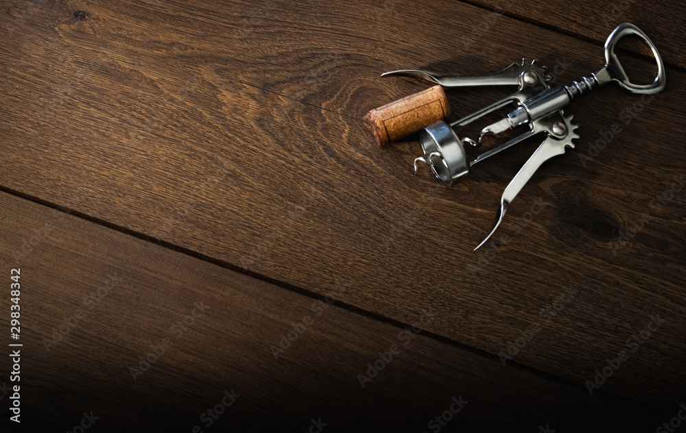 cork of wine bottle with corkscrew on wooden table cork of wine bottle with corkscrew on wooden table