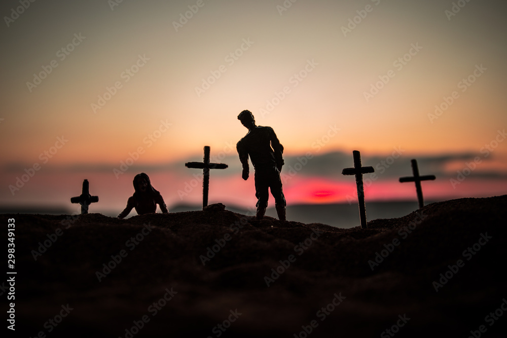 Silhouette some zombies on the cemetery walking around at sunset. Selective focus Silhouette some zombies on the cemetery walking around at sunset. Selective focus