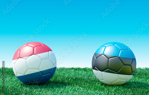 Two soccer balls in flags colors on green grass. Netherlands and Estonia. EURO 2020. Group C. 3d image