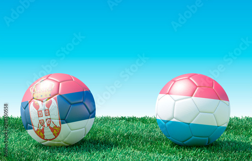 Two soccer balls in flags colors on green grass. Serbia and Luxembourg. EURO 2020. Group B. 3d image