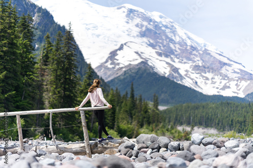 Hiker woman thinking if she can get to the top of the mountain photo