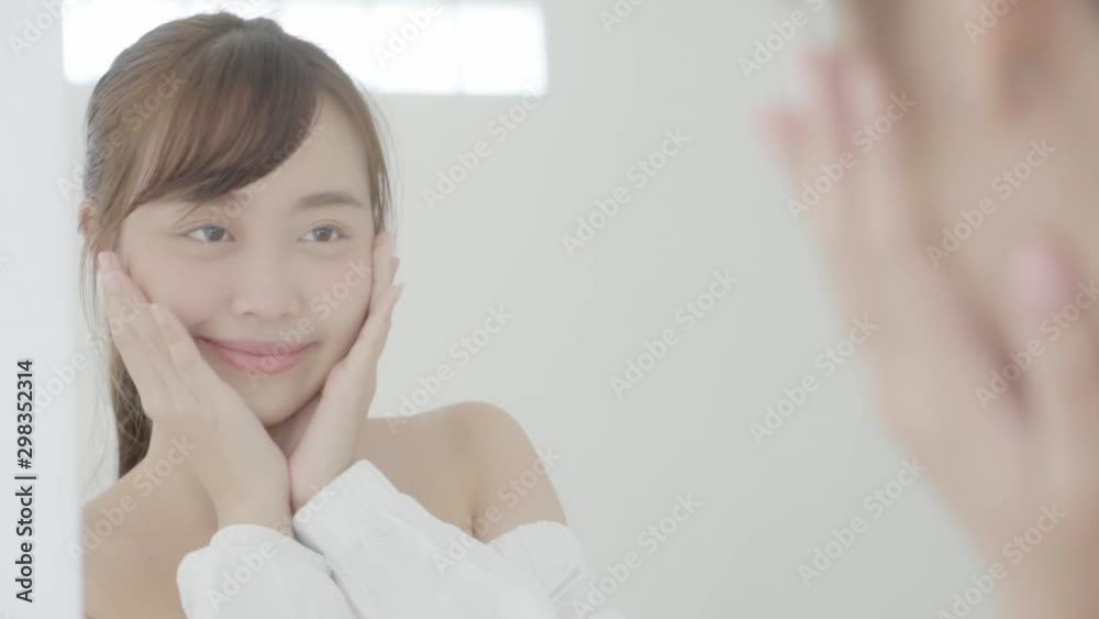 Beauty young asian woman smiling look at mirror of checking skin care ...