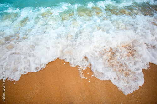 Soft wave of blue ocean selective focus on sandy beach  On Sandy Beach Background